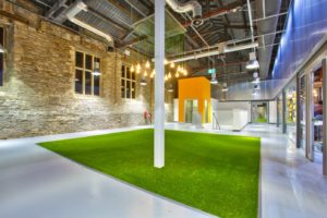 Photo of an event space at Engine Shed called Platform 14 with open space and an astroturf lawn