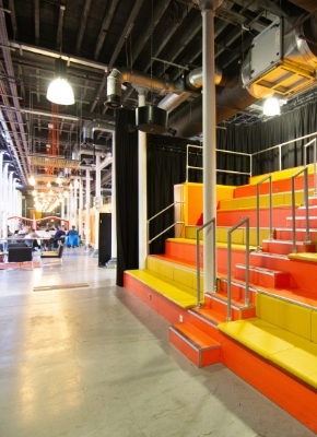 Photo showing an event space at Engine Shed called The Junction with banquet steps and a stage