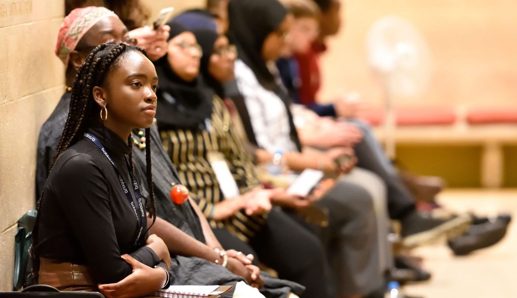 A group of people sitting listening at the Our Bristol, Our World Youth Conference 2019.