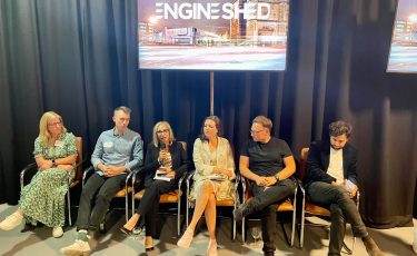 A photo of an event at Engine Shed featuring a panel of 5 speakers